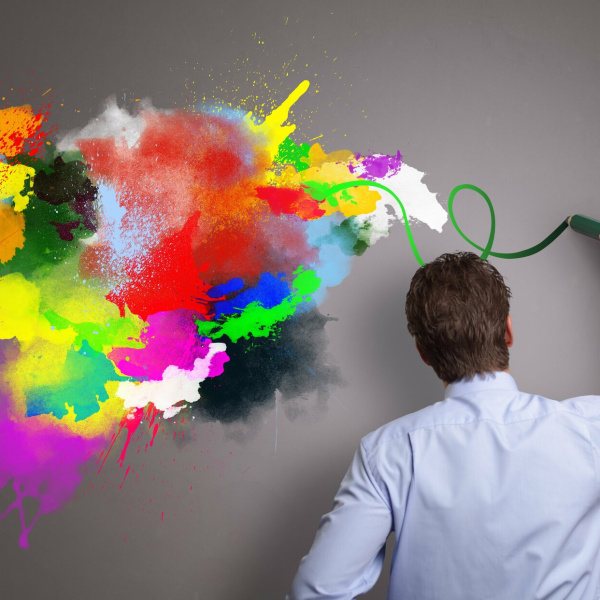 Businessman painting abstract colorful design on gray background concept for  business creativity, imagination and inspiration